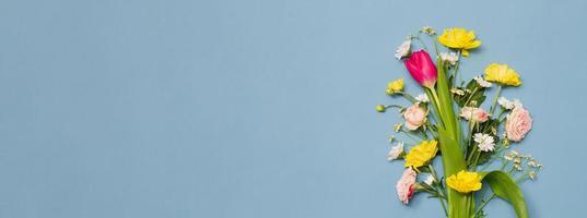 large varied spring bouquet on pastel blue background. photo