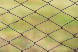 Metal mesh with traces of corrosion close-up on a natural background. Abstract background with repeating elements. photo