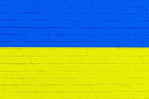 National flag of Ukraine on brick wall background photo