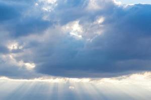 Rays of light shining through the rain clouds.light shining from heaven past the gray clouds. photo