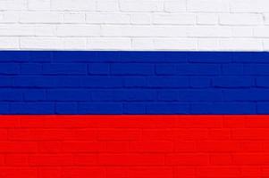 Russia flag painted on old brick wall texture background, white blue red photo