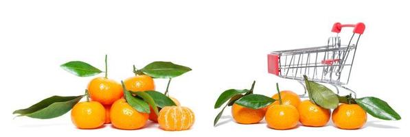 fresh mangerines and a shopping cart on a white isolated background photo