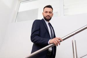presentable man in a business suit on the landing in the office, Concept of a modern entrepreneur photo