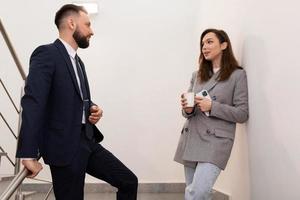 informal communication of colleagues at lunch break on the landing of the office photo