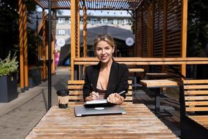 woman head working outdoors with laptop diary photo