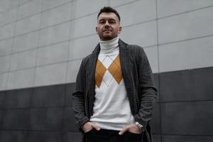 portrait of a brutal young man against a black and white wall photo