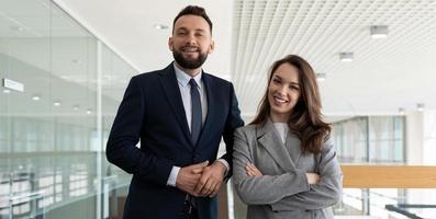 colleagues men and women in business suits on the background of the office space, concept of real estate services photo