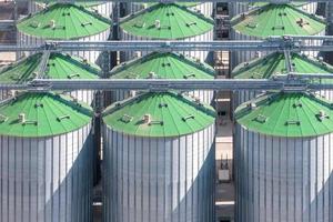 aerial view on rows of agro silos granary elevator with seeds cleaning line on agro-processing manufacturing plant for processing drying cleaning and storage of agricultural products photo