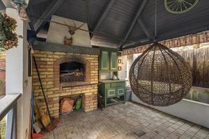 fireplace in a wooden gazebo near a country house photo