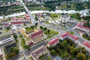 aerial panoramic view from great height on red roofs of historical center of old big city photo