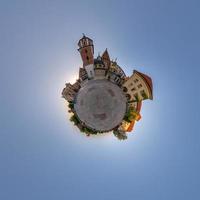 Little planet and spherical aerial 360 panorama view on street ancient medieval city with church and historic buildings photo