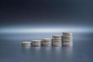 Stack of coins on black table photo