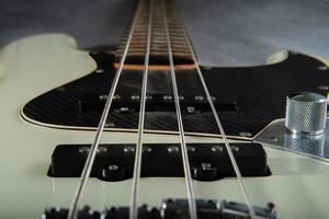 Close up guitar bass string details , four iron strings, white and black color photo