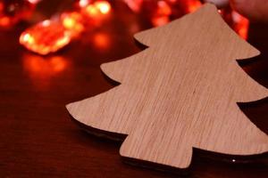 Christmas tree made of handmade wood on the background of a Christmas garland. Concept of christmas, new year, ecology. photo