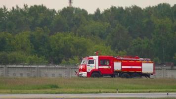 NOVOSIBIRSK, RUSSIA JUNE 10, 2020 - A Red Fire Truck drives through the Tolmachevo International Airport on a summer day. video
