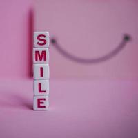 smile word with red cube letters, feelings and emotions photo