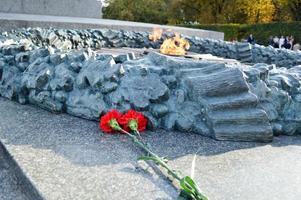 flowers lie near the Victory Monument photo