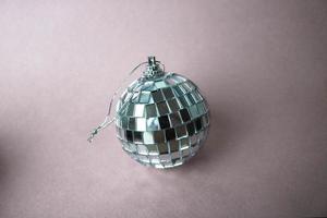 Silver mirror music club disco ball small round glass winter shiny decorative beautiful xmas festive Christmas ball, Christmas toy plastered on sparkles on a black and white background photo