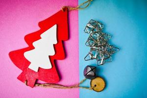 Festive New Year Christmas winter happy blue and pink beautiful joyful background with thinking little wooden and metal toy homemade tree. Flat lay. Top view. Holiday decorations. photo