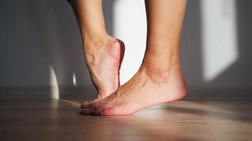 Close up, Beautiful Barefoot Female Feet in Bright Sunlight. Woman Stretches Her Legs. Body Care Concept. Warm Up the Ankles. video