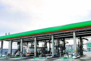 Large green industrial gas station for refueling vehicles, trucks and tanks with fuel, gasoline and diesel in the winter photo