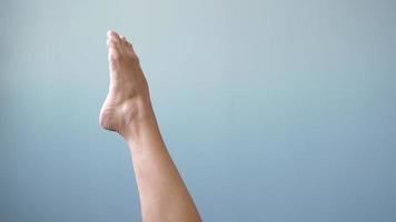 de belles jambes féminines nues bien entretenues avec une peau propre se déplacent gracieusement sur un fond gris. concept de soins des pieds et du corps. beauté et santé des pieds video