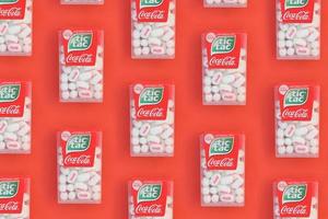 KHARKIV, UKRAINE - MAY 02, 2021 Many Tic Tac Candy packages with Coca-Cola taste. Tic tac is popular due its minty fresh taste and easy to carry. Hard mints produced by Ferrero since 1968 photo