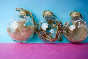 Three small round glass transparent vintage improvised elegant hipster decorative beautiful festive New Year's balls, Christmas decorations with hay, straw inside and with a star photo