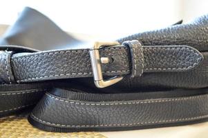 Metal buckle, buckle on a black leather strap. photo