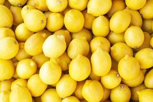 Fresh colorful lemons close-up background photo