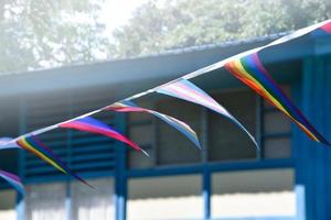 Lgbtq flags were hung on wire to decorate outside balcony of restaurant, soft and selective focus, concept for LGBTQ plus gender celebrations in pride month around the world. photo