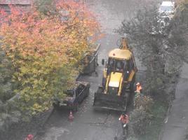 KIEV, UKRAINE - OCTOBER 24, 2022 Road works carry out repairs with machinery photo