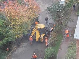 KIEV, UKRAINE - OCTOBER 24, 2022 Road works carry out repairs with machinery photo