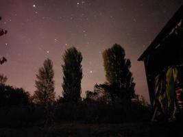 Bright night starry sky in the village photo