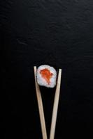 Sushi with tuna salmon rice and chopsticks on an isolated background photo