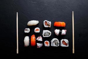 japanese sushi food. Maki ands rolls with tuna, salmon, shrimp, crab and avocado. Top view of assorted sushi. photo