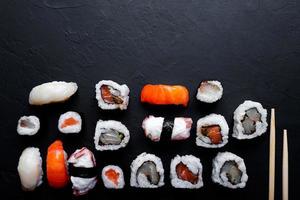 japanese sushi food. Maki ands rolls with tuna, salmon, shrimp, crab and avocado. Top view of assorted sushi. photo
