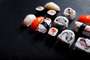 japanese sushi food. Maki ands rolls with tuna, salmon, shrimp, crab and avocado. Top view of assorted sushi. photo