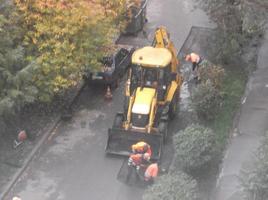 KIEV, UKRAINE - OCTOBER 24, 2022 Road works carry out repairs with machinery photo