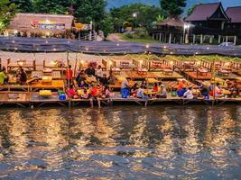 Vangvieng.lao-11 Dec 2017.Beautiful view of nam song river with Tourist on riverside restaurant and the mountain in the night at Vangvieng city Lao.Vangvieng City The famous holiday destination town. photo