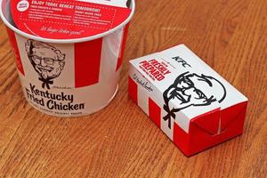 Washington USA  June 01 2022  American style fried chicken Kentucky Fly Chicken or KFC put in a bucket and put in a box to take home. KFC fried chicken in a package, a bucket photo