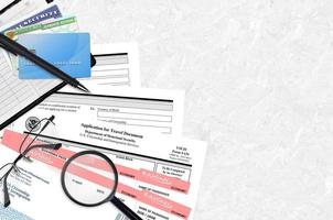 USCIS form I-131 Application for travel document lies on flat lay office table and ready to fill. U.S. Citizenship and Immigration services paperwork concept photo