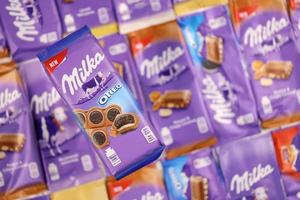 KHARKOV, UKRAINE - DECEMBER 8, 2020 Many wrappings of purple Milka chocolate. Milka is a Swiss brand of chocolate confection manufactured by company Mondelez International photo