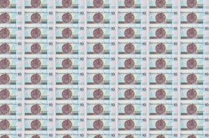 10 Polish zloty bills printed in money production conveyor. Collage of many bills. Concept of currency devaluation photo