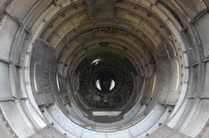 The inner metal lining of empty military fighter. Abandoned aircraft inside view photo