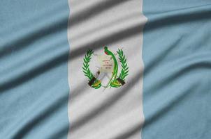 Guatemala flag  is depicted on a sports cloth fabric with many folds. Sport team banner photo