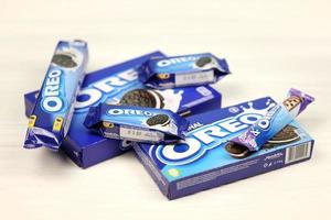 KHARKOV, UKRAINE - DECEMBER 8, 2020 Oreo sandwich cookies and blue product boxes on white table. Oreo is a sandwich cookie with a sweet cream is the best selling cookie in US photo