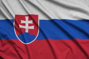 Slovakia flag  is depicted on a sports cloth fabric with many folds. Sport team banner photo