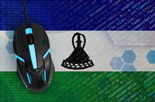 Lesotho flag  and computer mouse. Digital threat, illegal actions on the Internet photo
