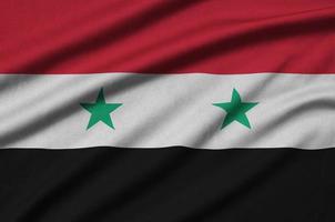 Syria flag  is depicted on a sports cloth fabric with many folds. Sport team banner photo